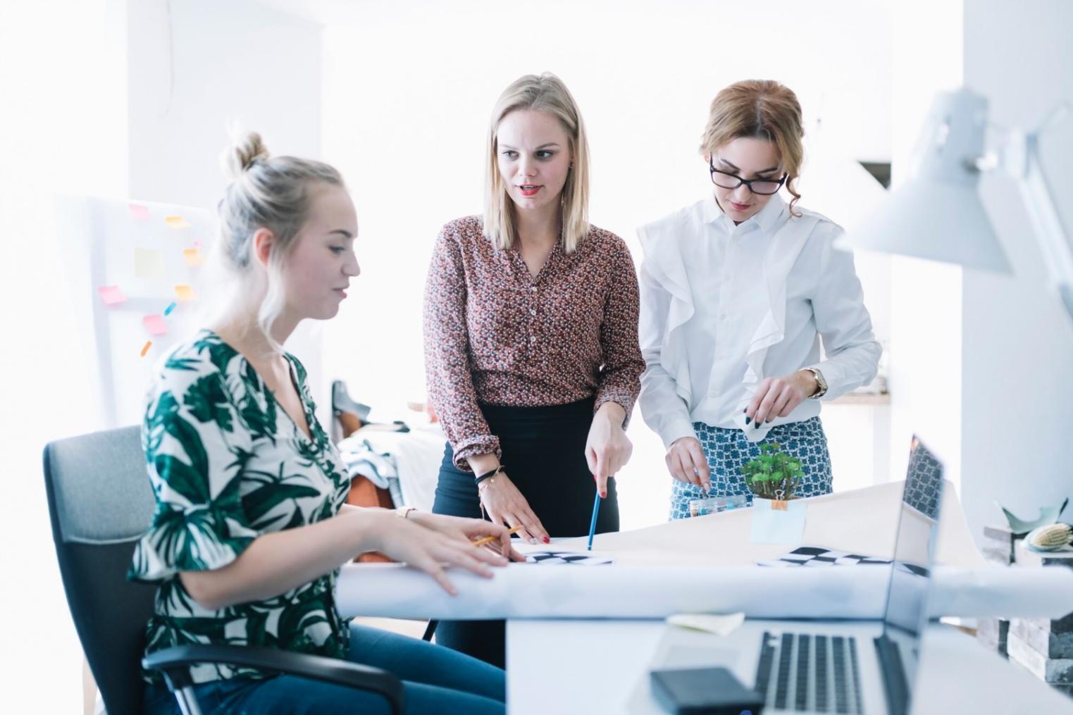 Students engaging in interactive budget planning exercise with financial worksheets and calculators